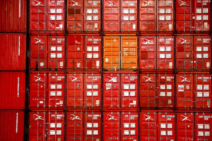 a large amount of red containers stacked on top of each other
